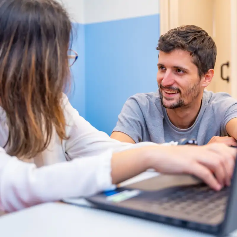 Young people conversing in front of the computer